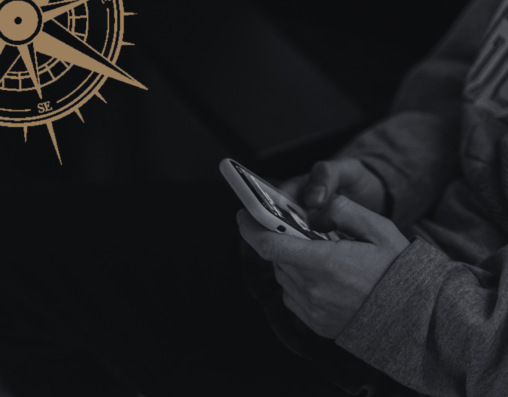 Leader holding phone in the dark unable to stop watching their business