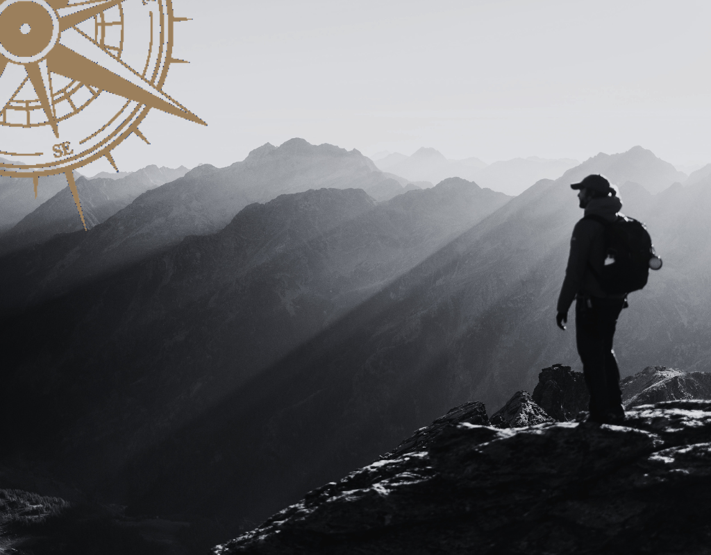 Leader standing at a mountain summit facing the transition nobody prepares you for